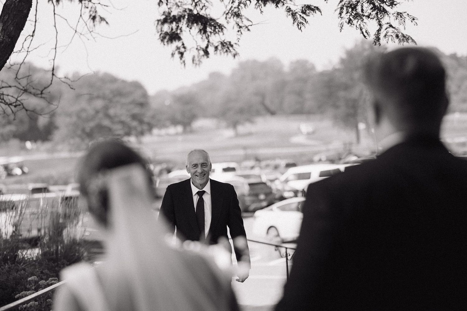 A series of black and white wedding photos showing candid moments during an outdoor celebration.
