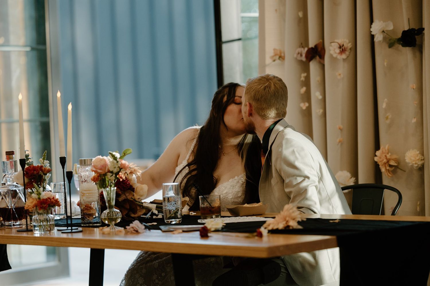 Bride and groom share a kiss during the wedding reception at Pinewood Weddings and Events.