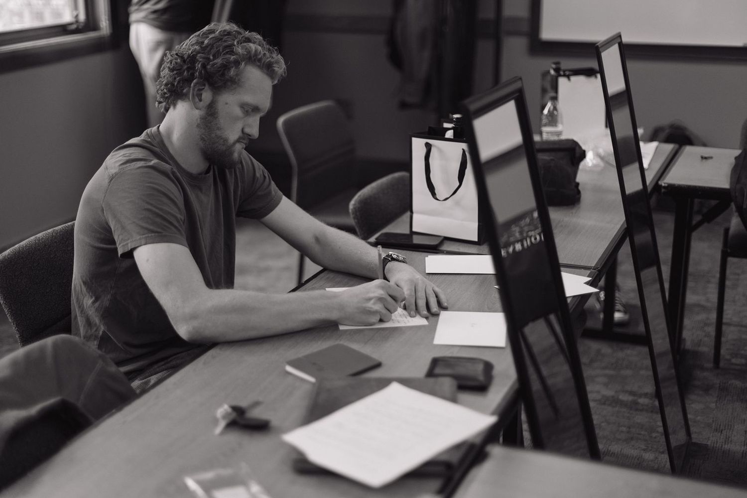 Person working at desk with computer monitors in office setting.