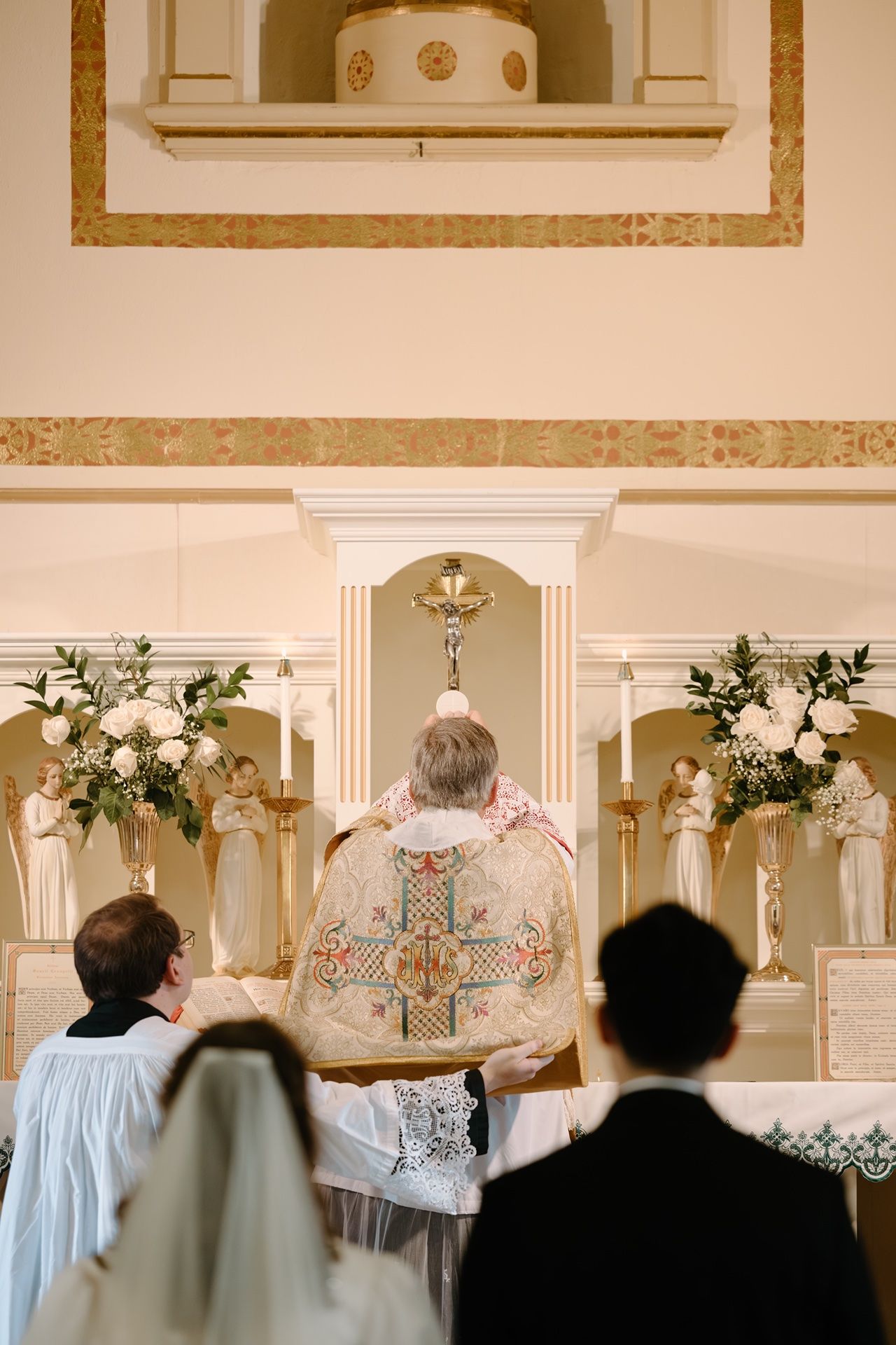 Catholic wedding photography of the consecration of the eucharist