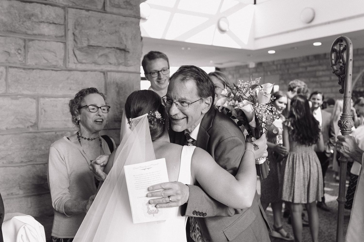 Black and white candid shots of wedding reception moments showing guests interacting and celebrating.