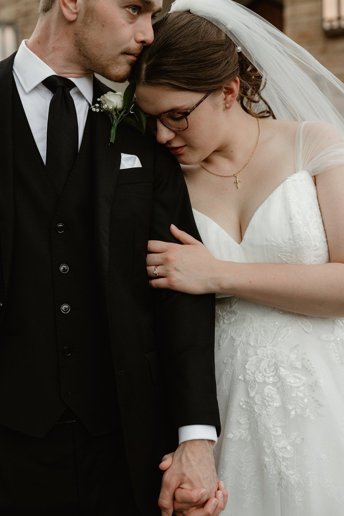 Close-up view of a couple sharing an intimate moment in formal wedding attire.