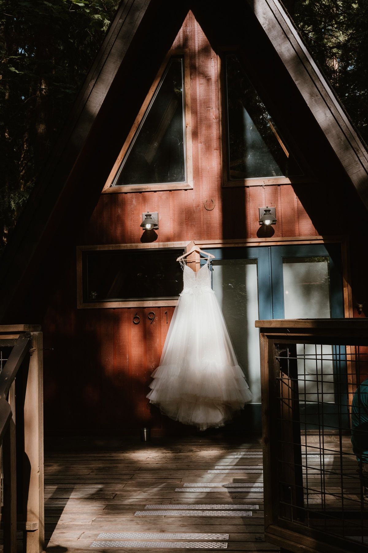 Dress hanging on an A-frame cabin for a PNW adventure elopement