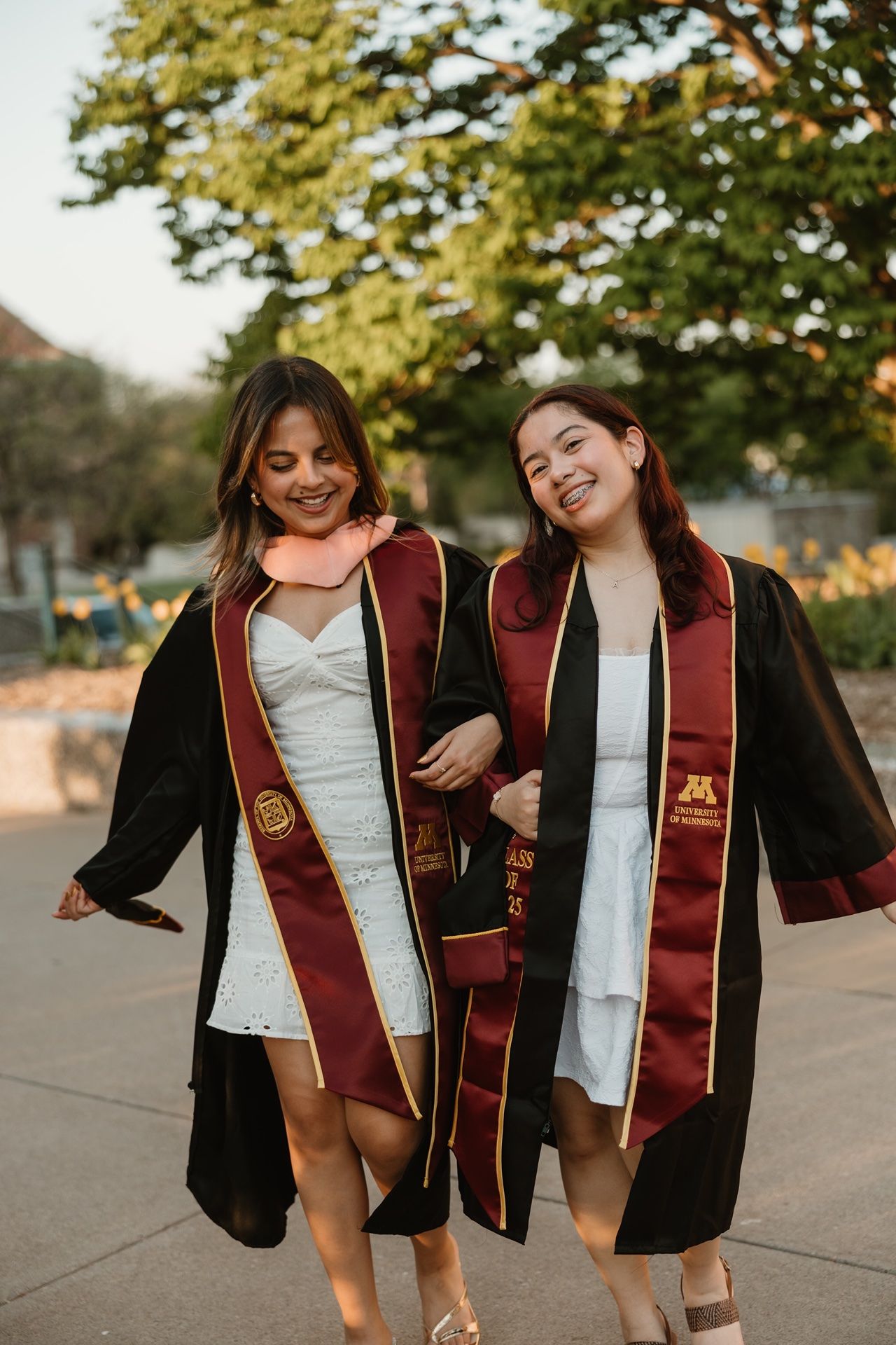 Minneapolis graduation photographer documenting two best friends during a college graduation session