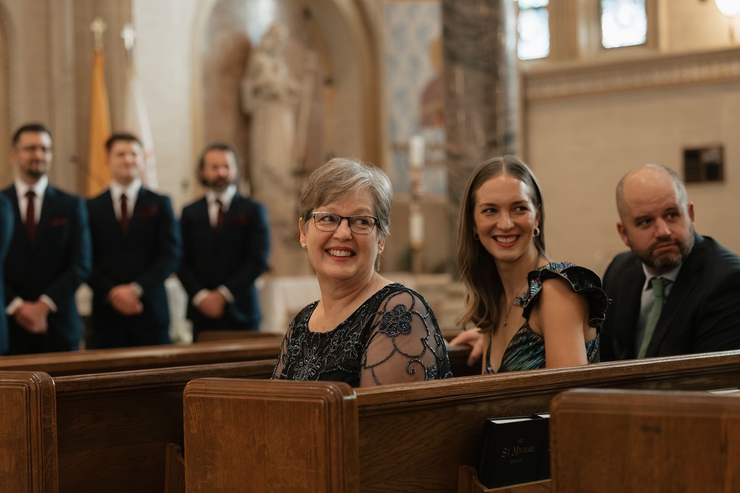 Mother watching bride walking down the aisle at a Catholic wedding