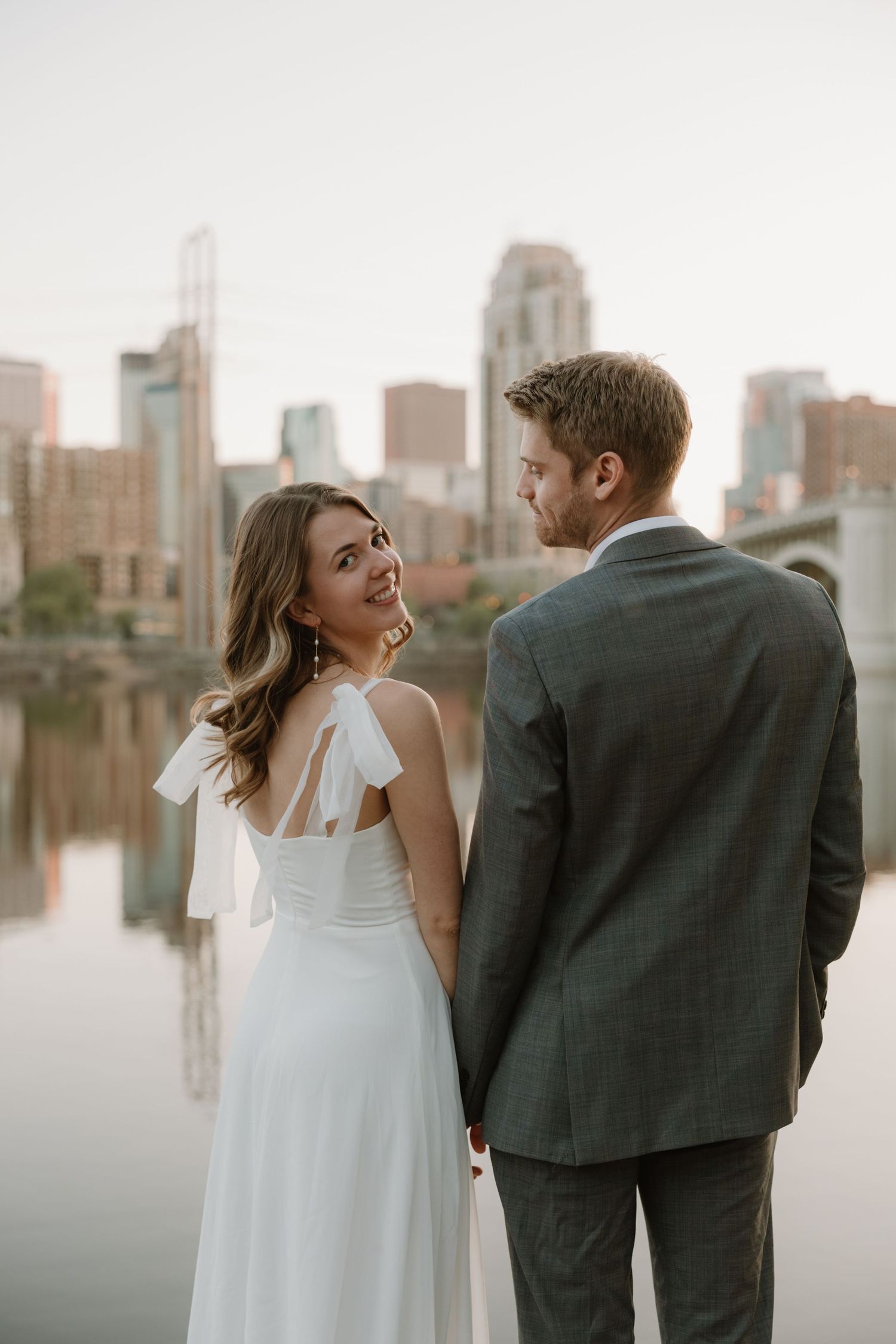 Minneapolis engagement photographer guiding a couple through relaxed poses