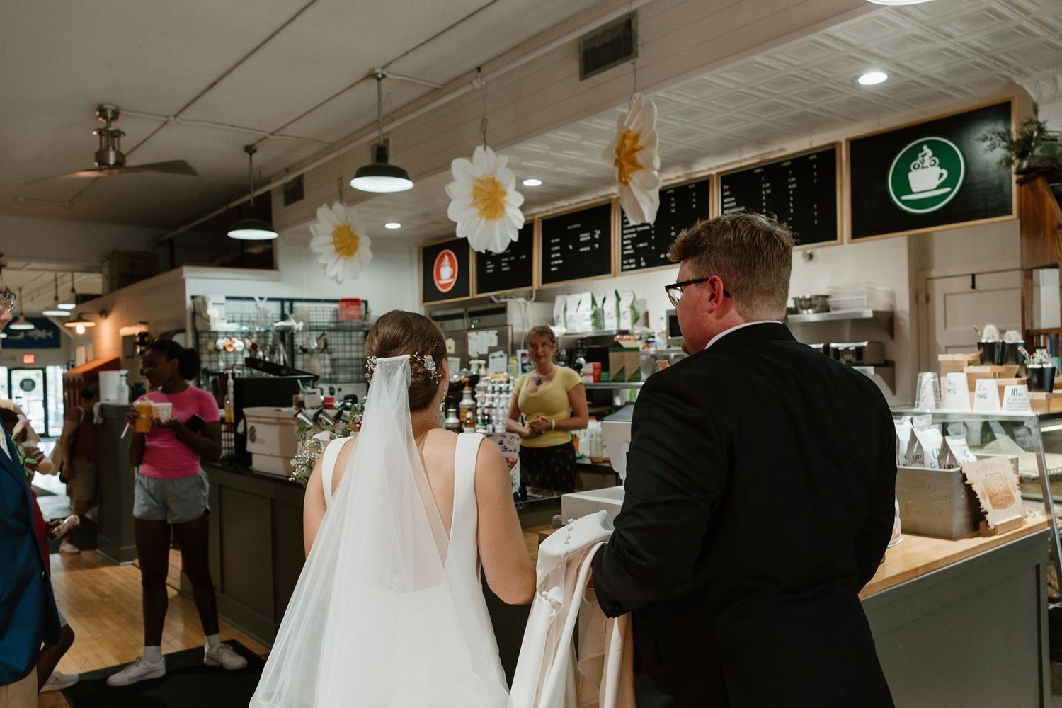 A bride and groom share an intimate dance together at their wedding reception under soft lighting.