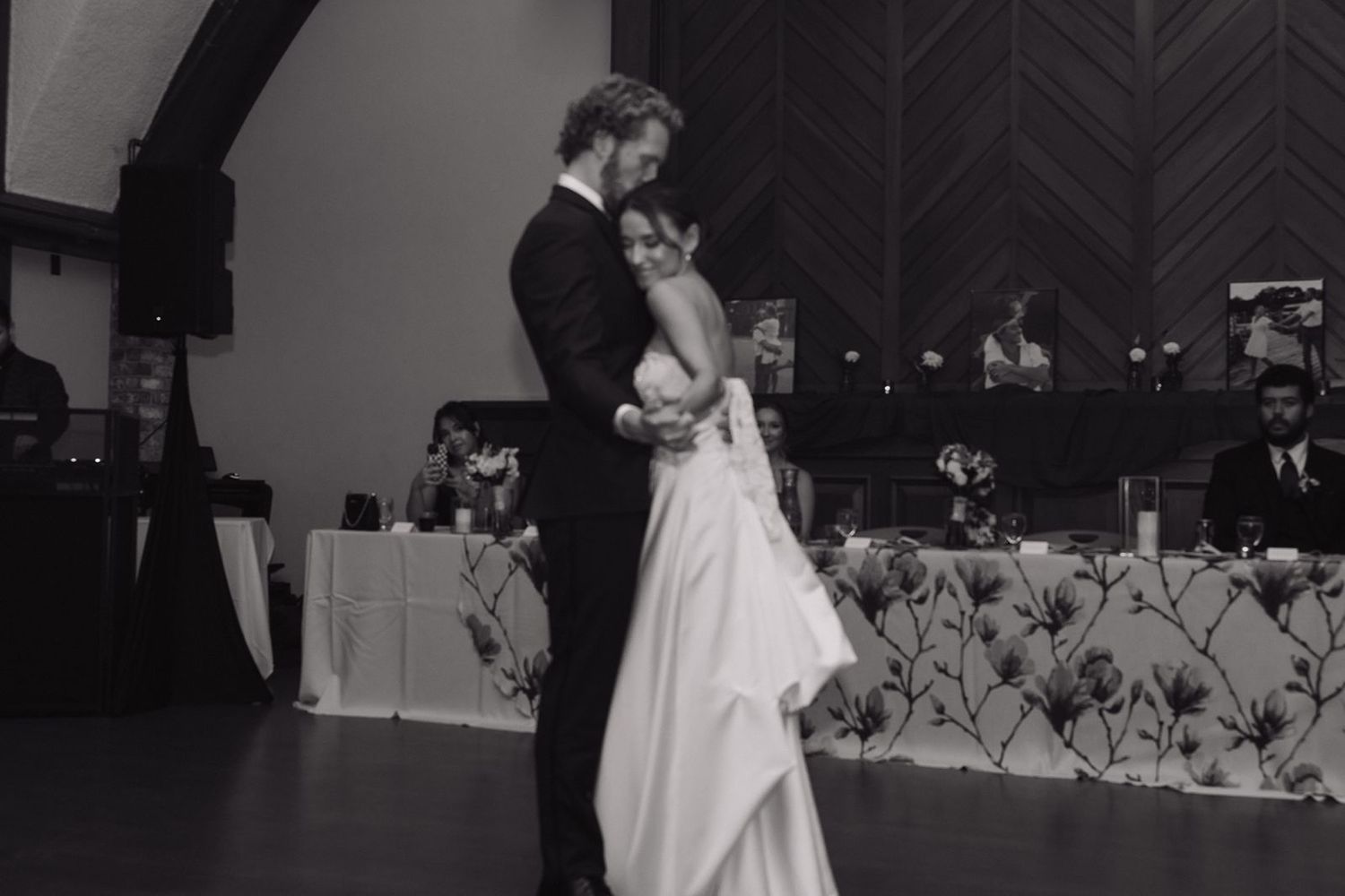 Black and white photo captures intimate dance moment at wedding reception.