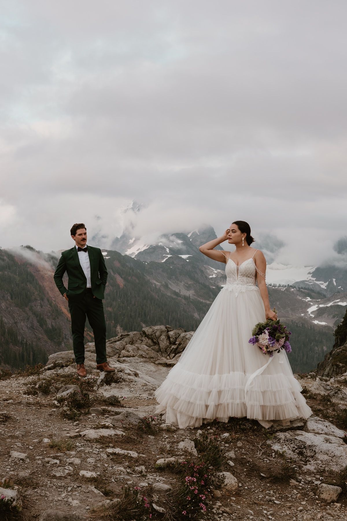 Adventure elopement photographer capturing a couple standing on a rocky overlook at Artist's Point in the Mount Baker area of Washington