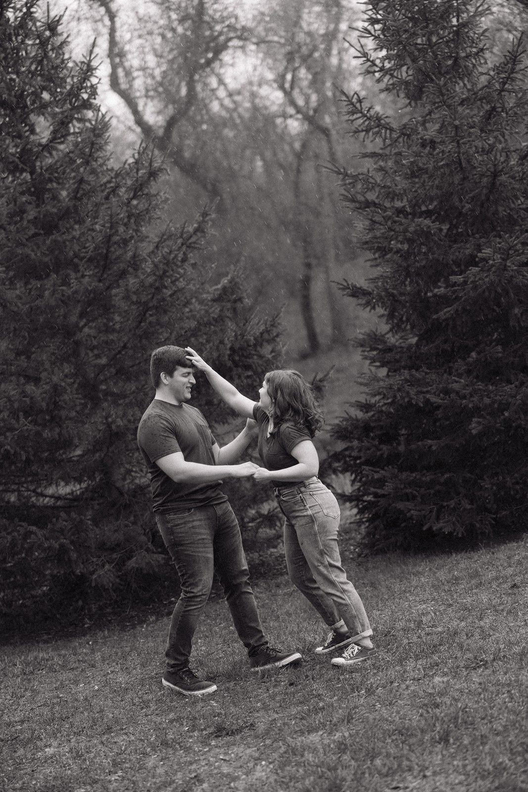 A playful sequence of dance moves captured in black and white photography against a forest backdrop.