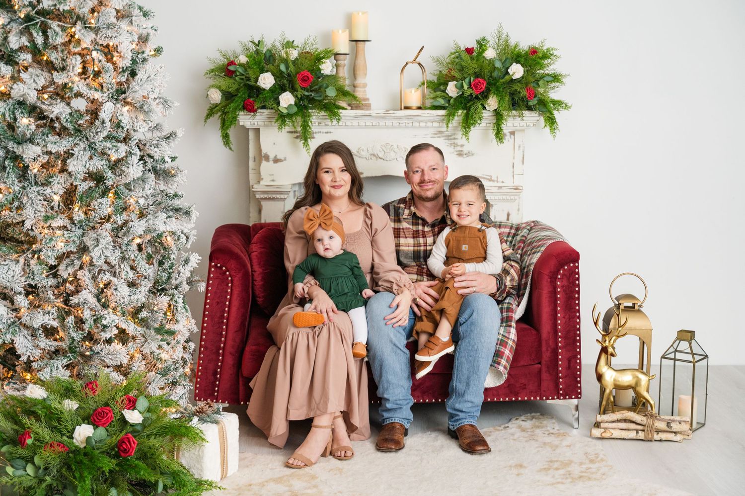 Festive holiday scene with Christmas tree and decorated mantle backdrop.