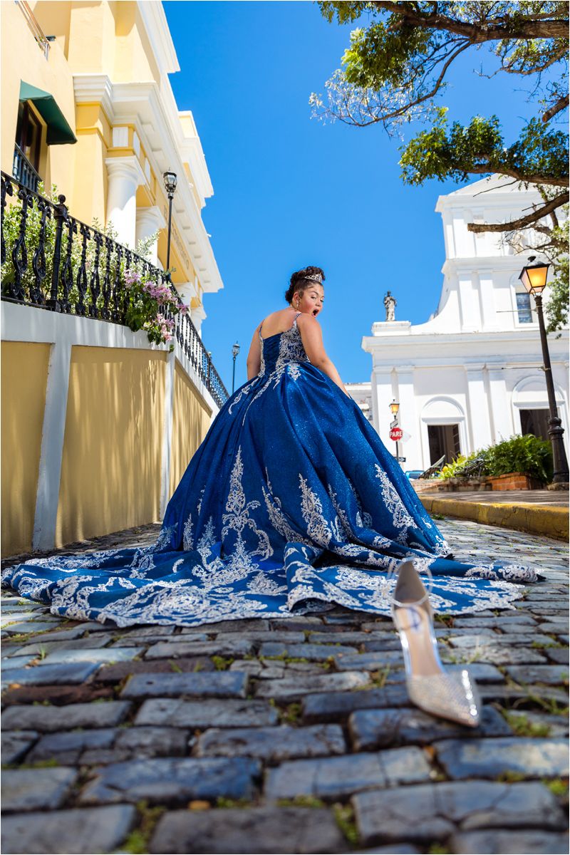 A stunning royal blue quinceañera gown with silver embroidery photographed on cobblestone streets in Old San Juan, Puerto Rico.