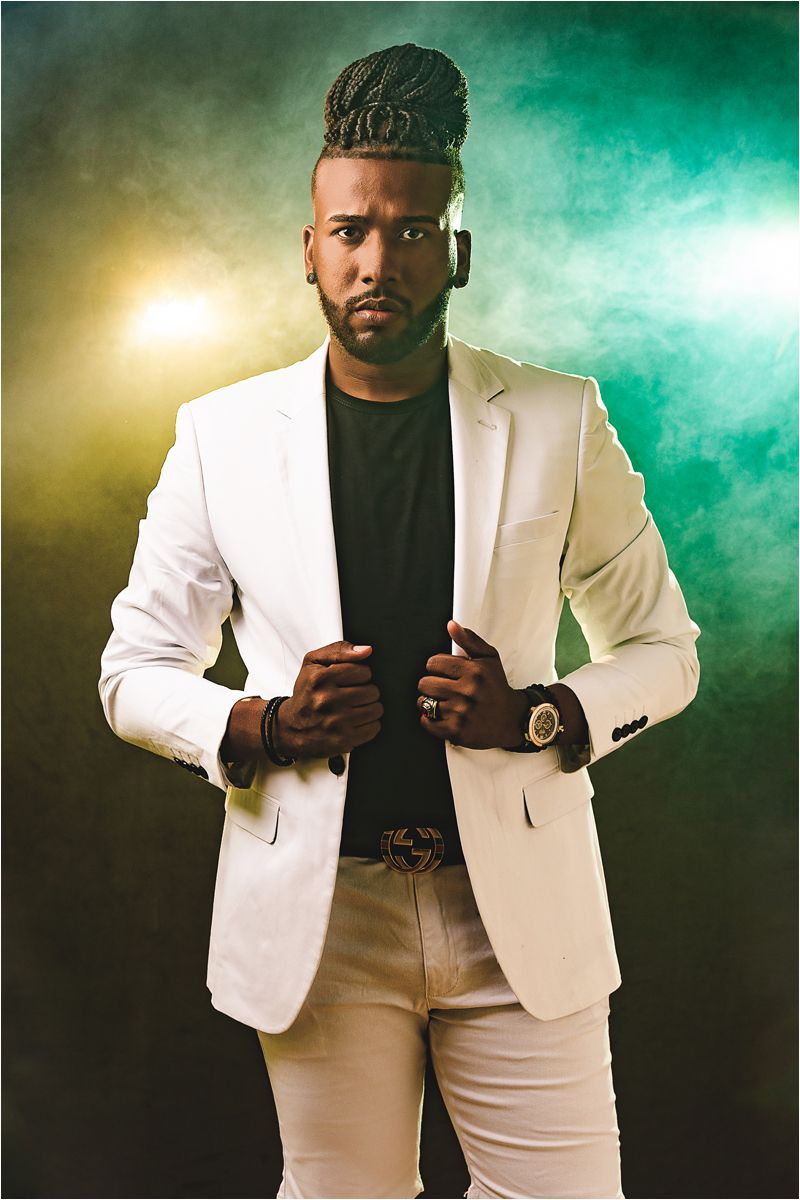 Professional portrait series showing a man in a white blazer and black shirt against a dramatic green and gold backdrop.