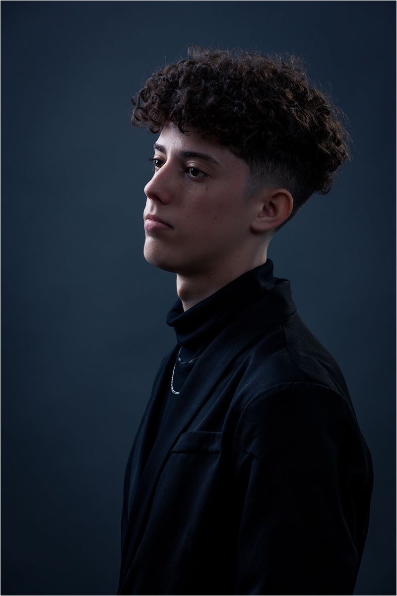 Dramatic side profile portrait series in dark lighting showing someone wearing a black jacket against a dark background.