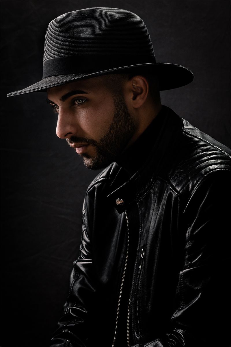 Dramatic black and white portrait series showing a person in a leather jacket and fedora hat against dark background.