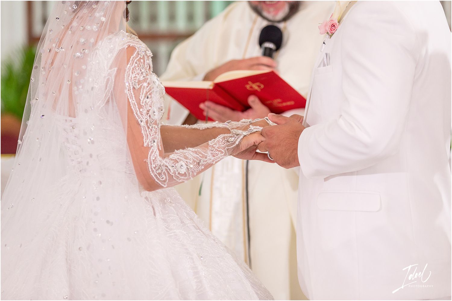 Close-up of hands exchanging wedding rings during a traditional church ceremony.