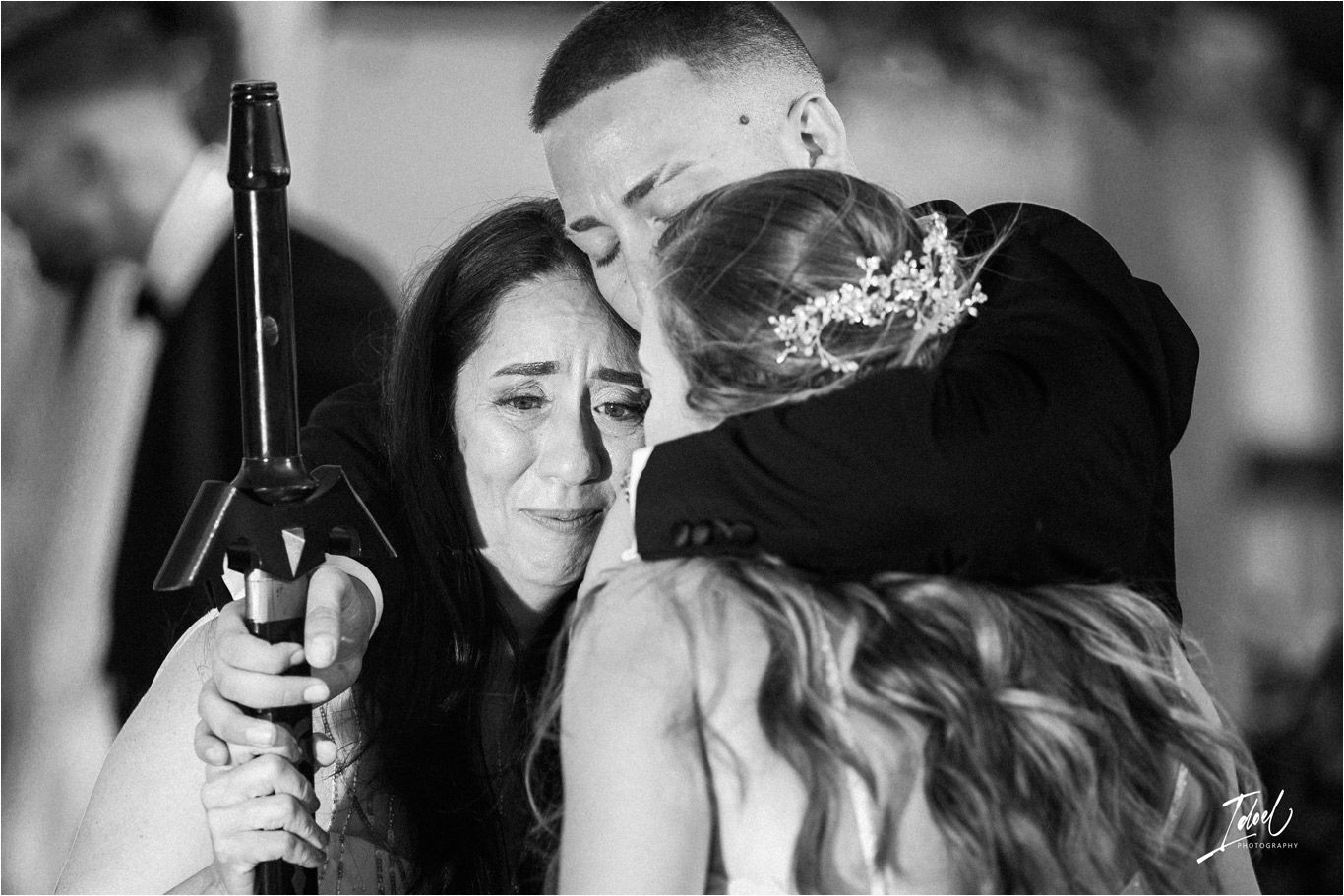 An emotional black and white moment captured during a wedding celebration.