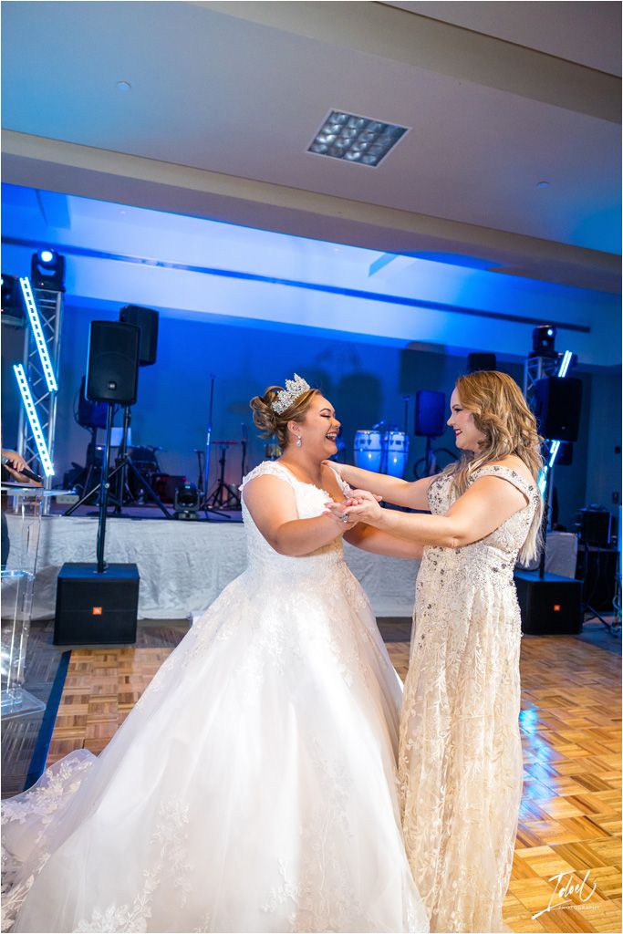 An emotional moment shared between two attendees during a wedding celebration.