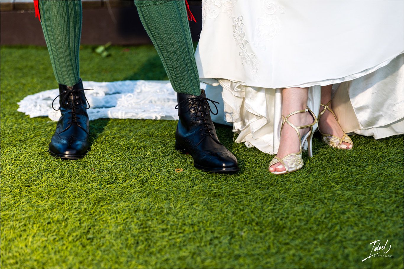 Close-up of traditional Scottish wedding footwear and bridal shoes on artificial grass.
