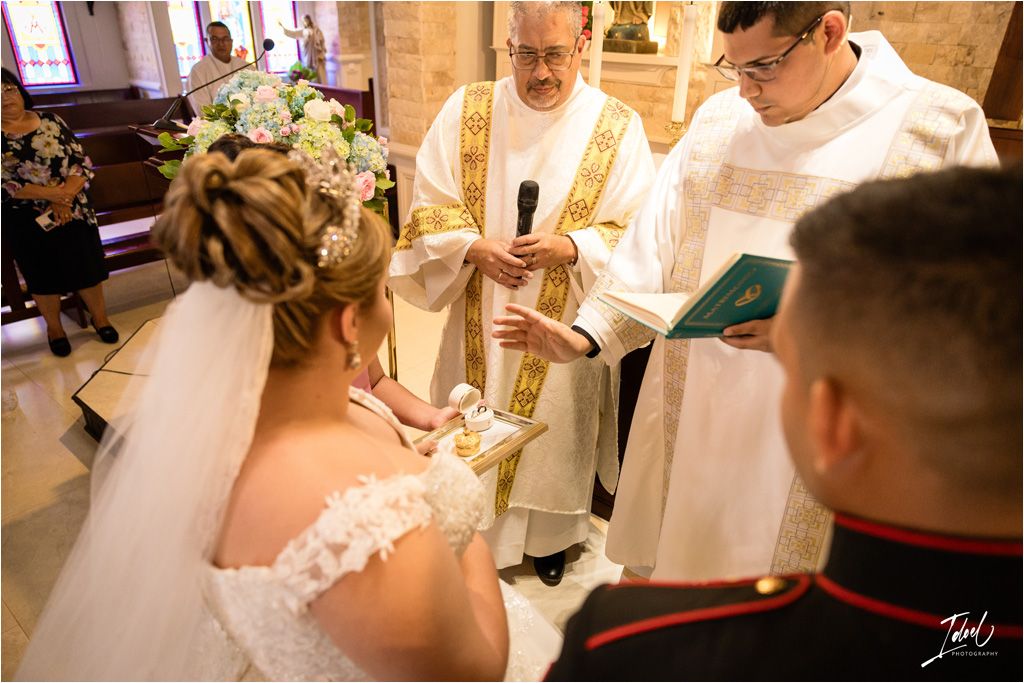 Religious wedding ceremony with clergy members conducting a traditional blessing ritual at the altar.