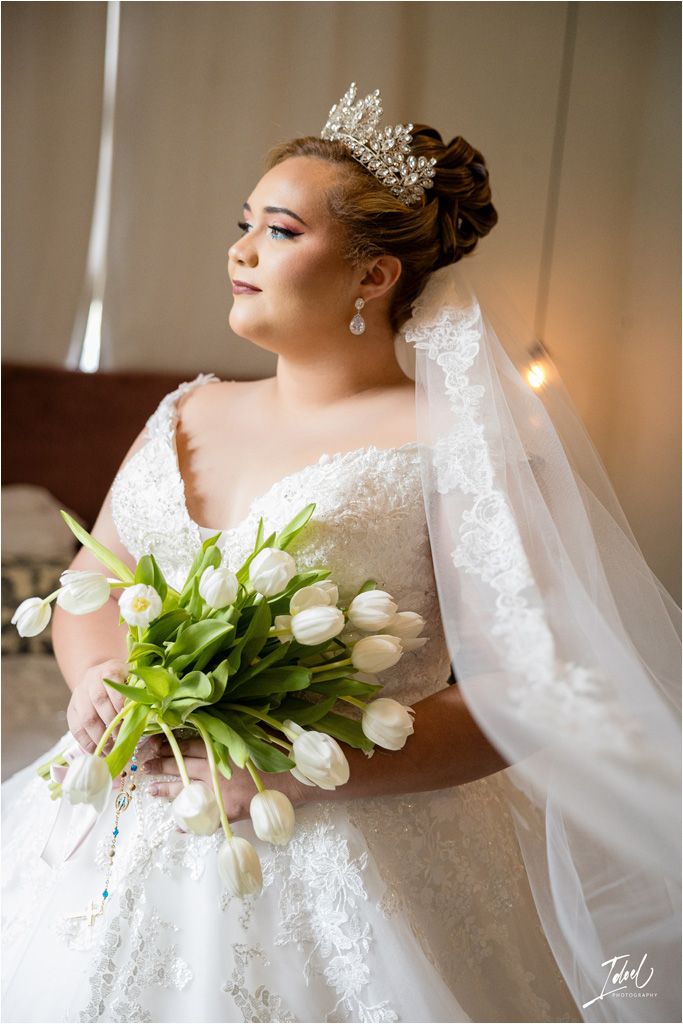 Bridal portrait featuring white tulips and crystal crown with veil.