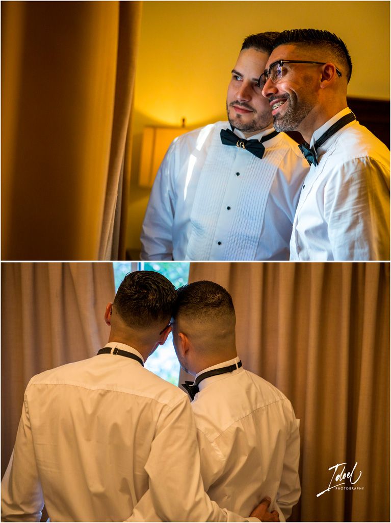 Two people in formal black bow ties and white dress shirts share an intimate moment at a wedding reception.