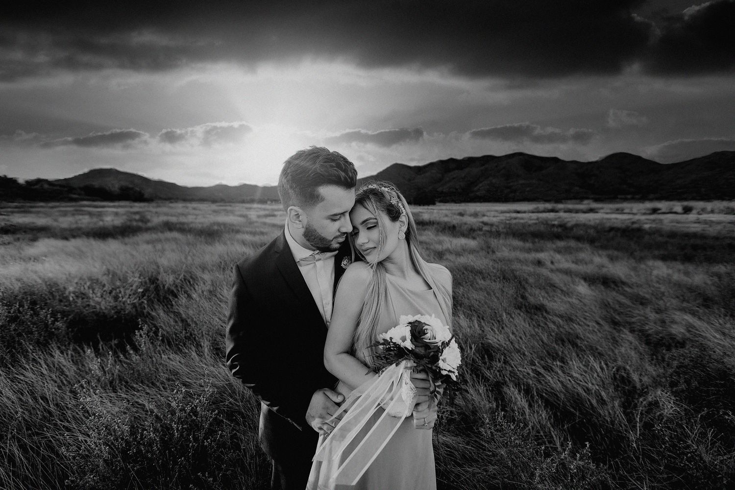 Dramatic black and white wedding portraits in a mountain landscape.