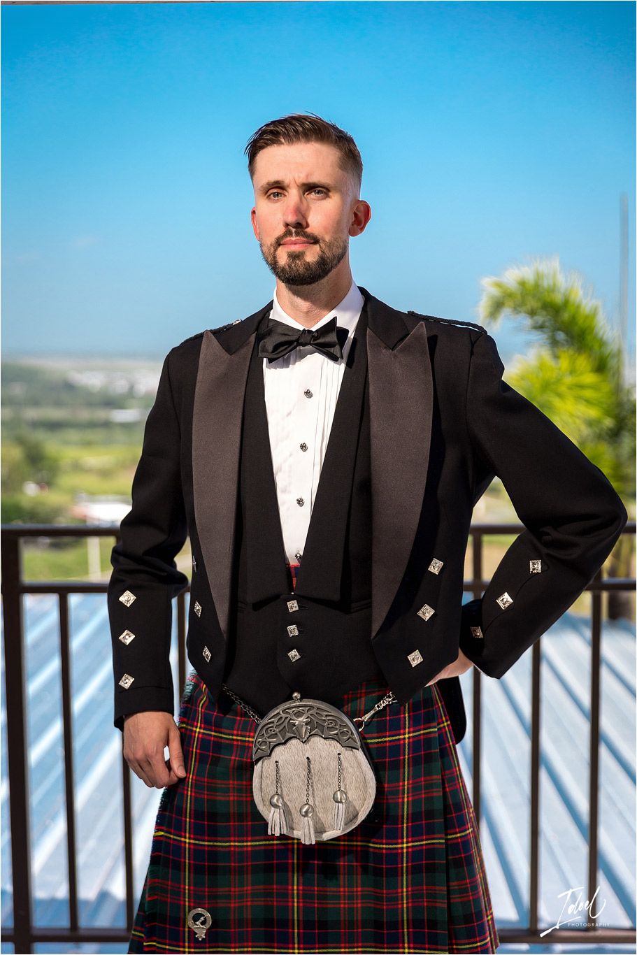 Formal Scottish wedding attire featuring black jacket, bow tie and traditional tartan kilt.