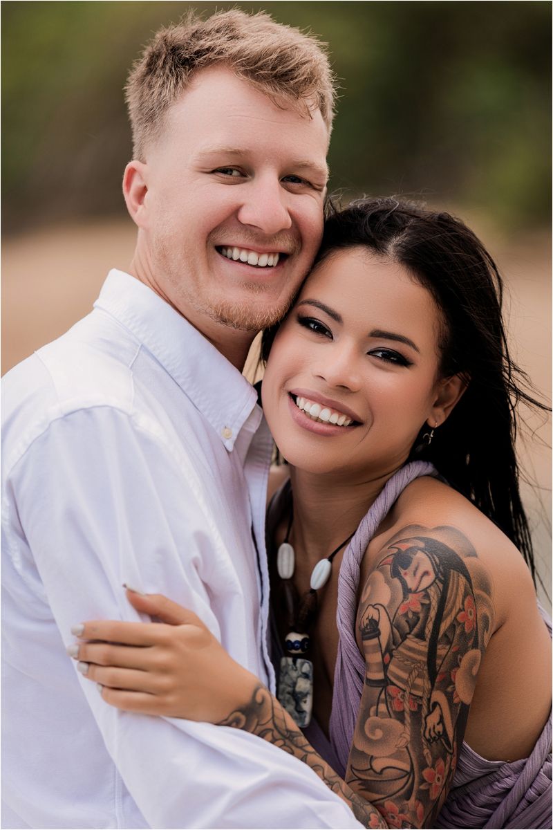A couple shares intimate moments outdoors in a romantic photoshoot series showing their affection and laughter.
