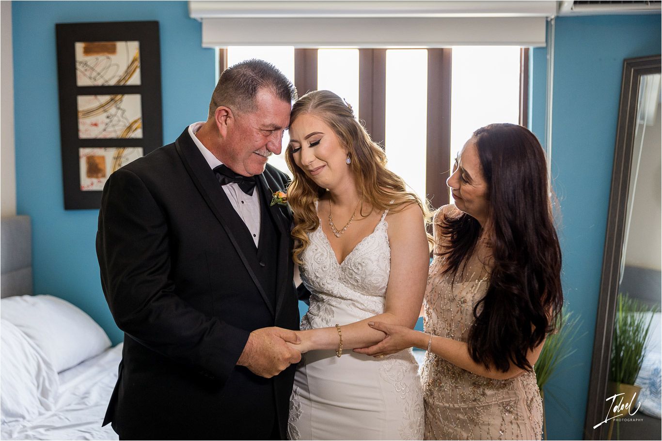 Wedding preparation scene in blue bedroom with bride getting ready for ceremony.