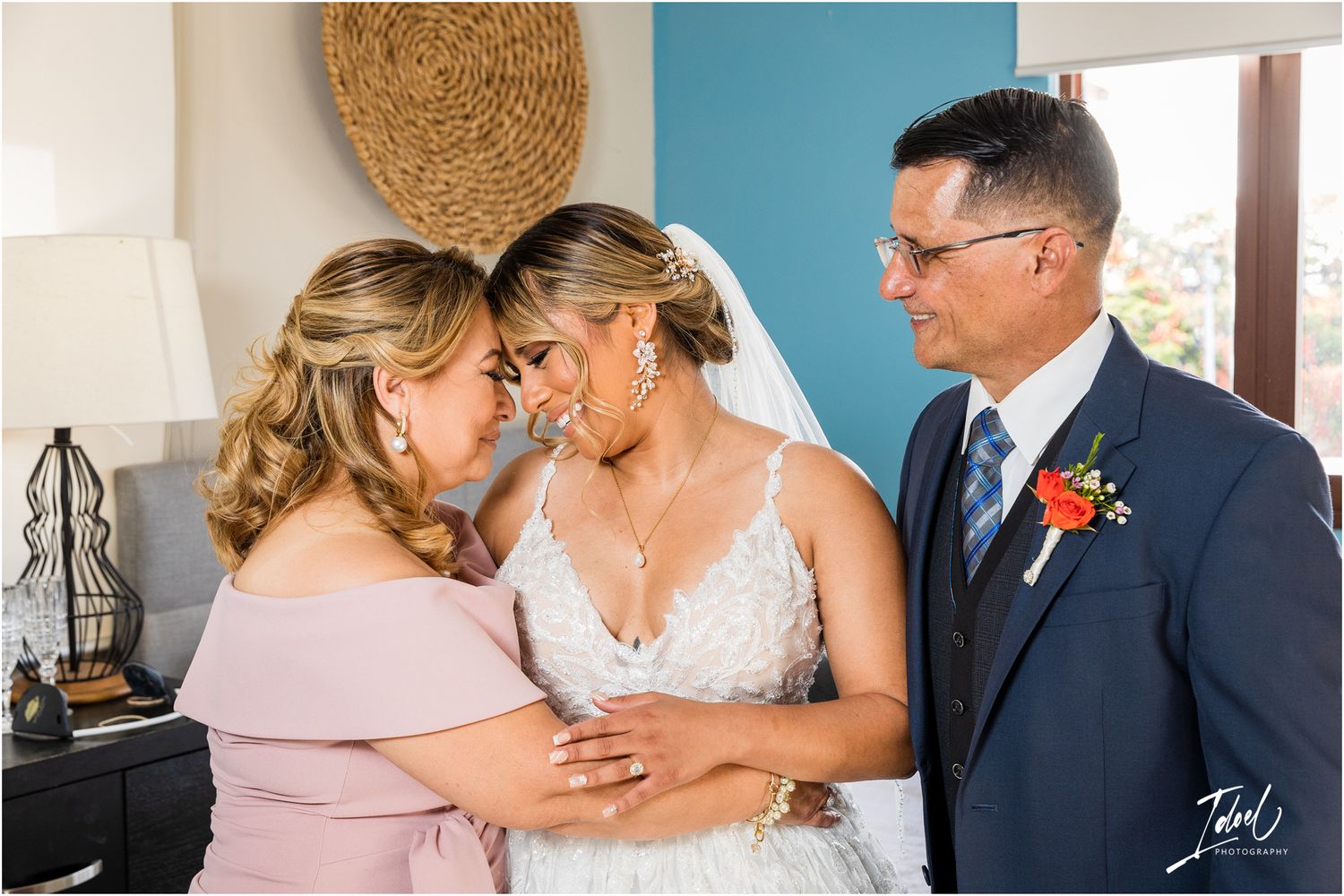 Emotional wedding moment shared between bride and wedding party members in formal attire.