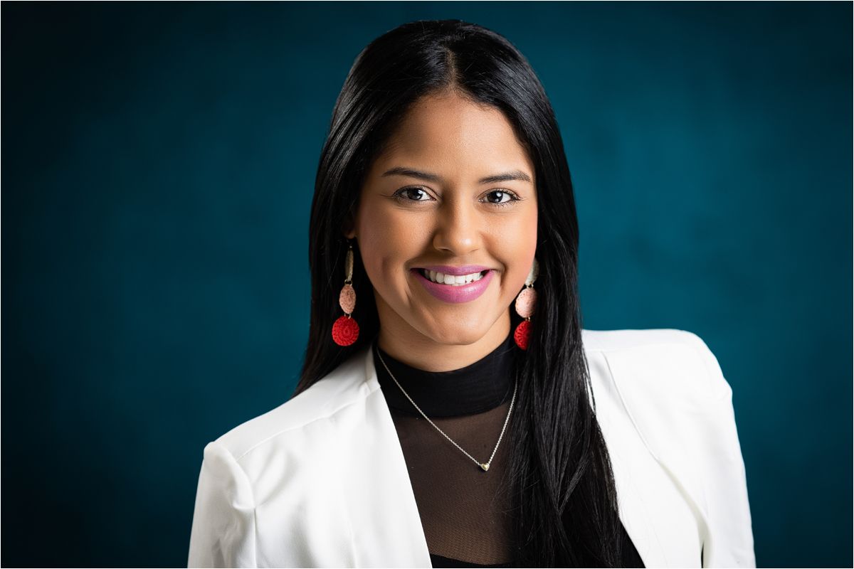 Professional headshot series showing someone in a white blazer against a dark blue background with warm smiles.