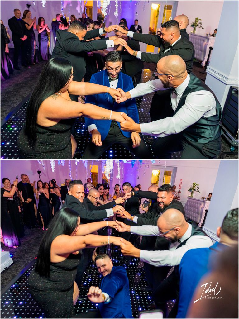 Party guests on a dance floor having fun with synchronized dance moves during a celebration event with purple lighting.