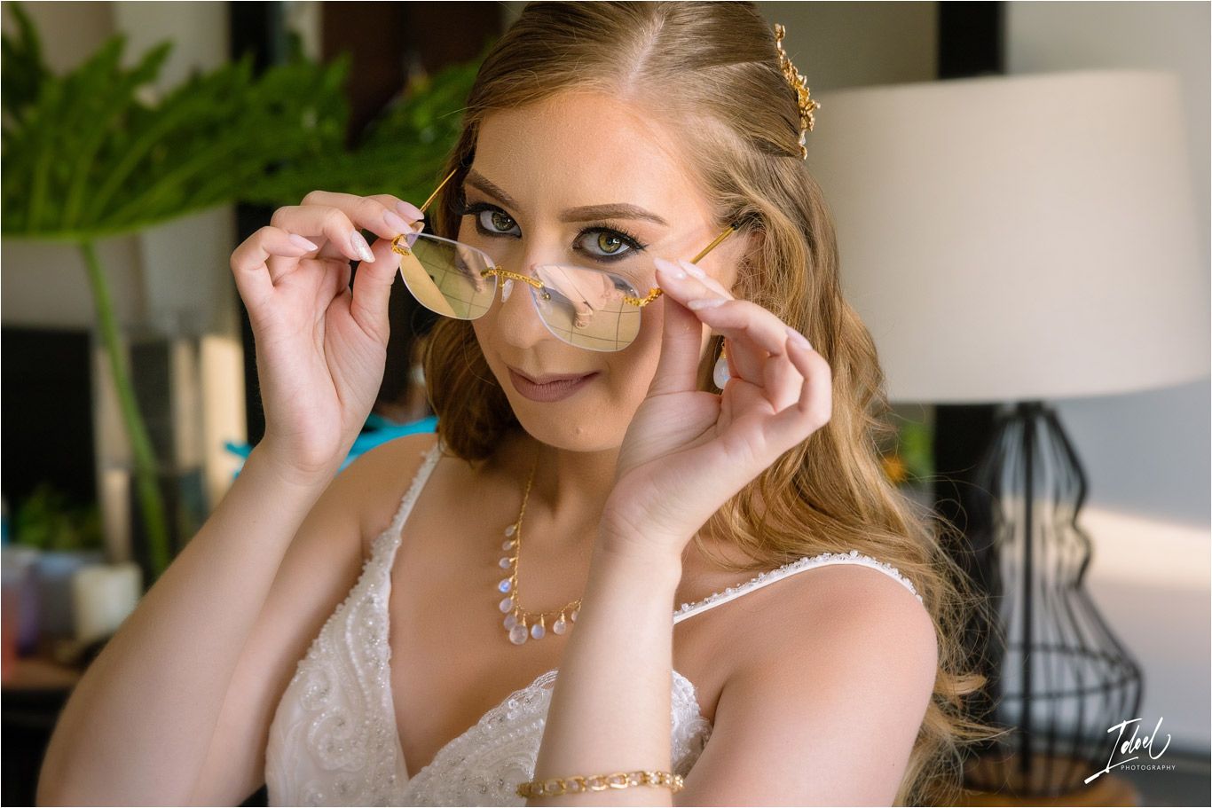 Close-up of person adjusting stylish glasses while wearing a white lace dress.