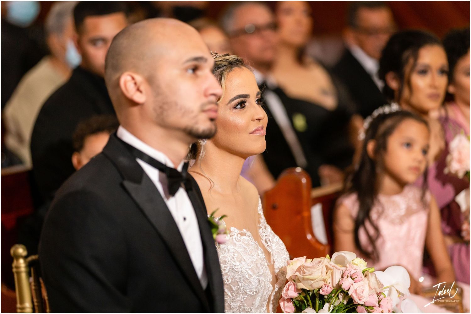 Elegant couple during their wedding ceremony in traditional formal attire.