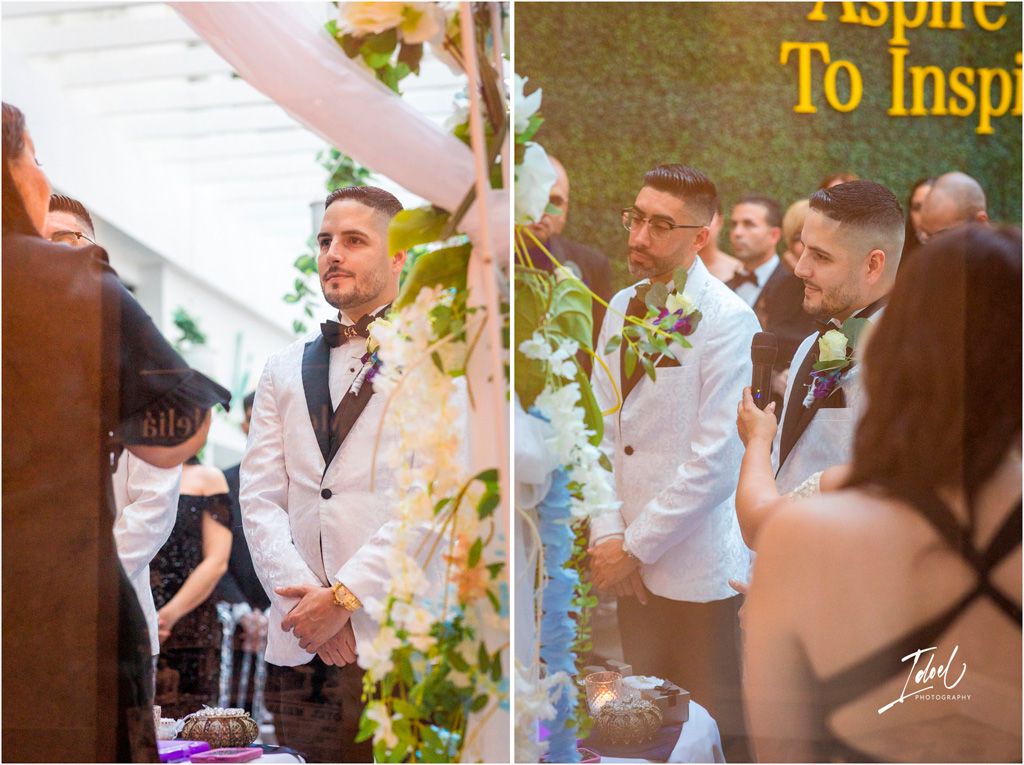 Wedding ceremony decor features white floral arrangements and 'Aspire to Inspire' signage in an elegant indoor venue.