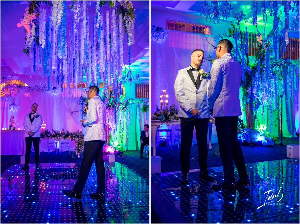 Couple dancing at an elegant reception with blue and purple lighting and hanging decorations creating a magical atmosphere.