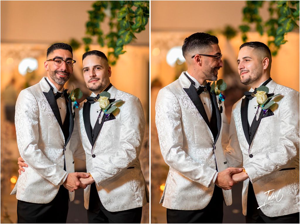 Two people in matching white jacquard tuxedo jackets and black bow ties share an intimate moment at their wedding.