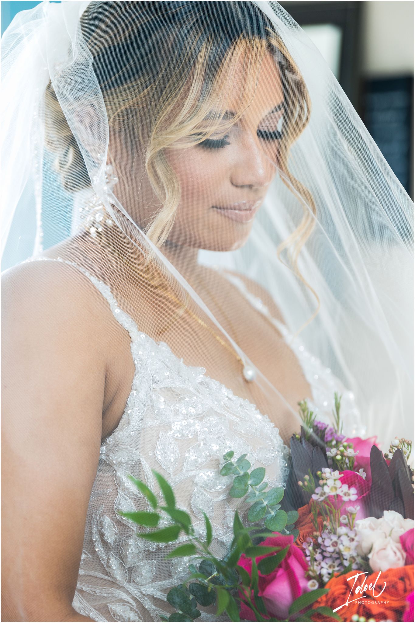 Ethereal bridal portrait featuring soft makeup and delicate veil details.
