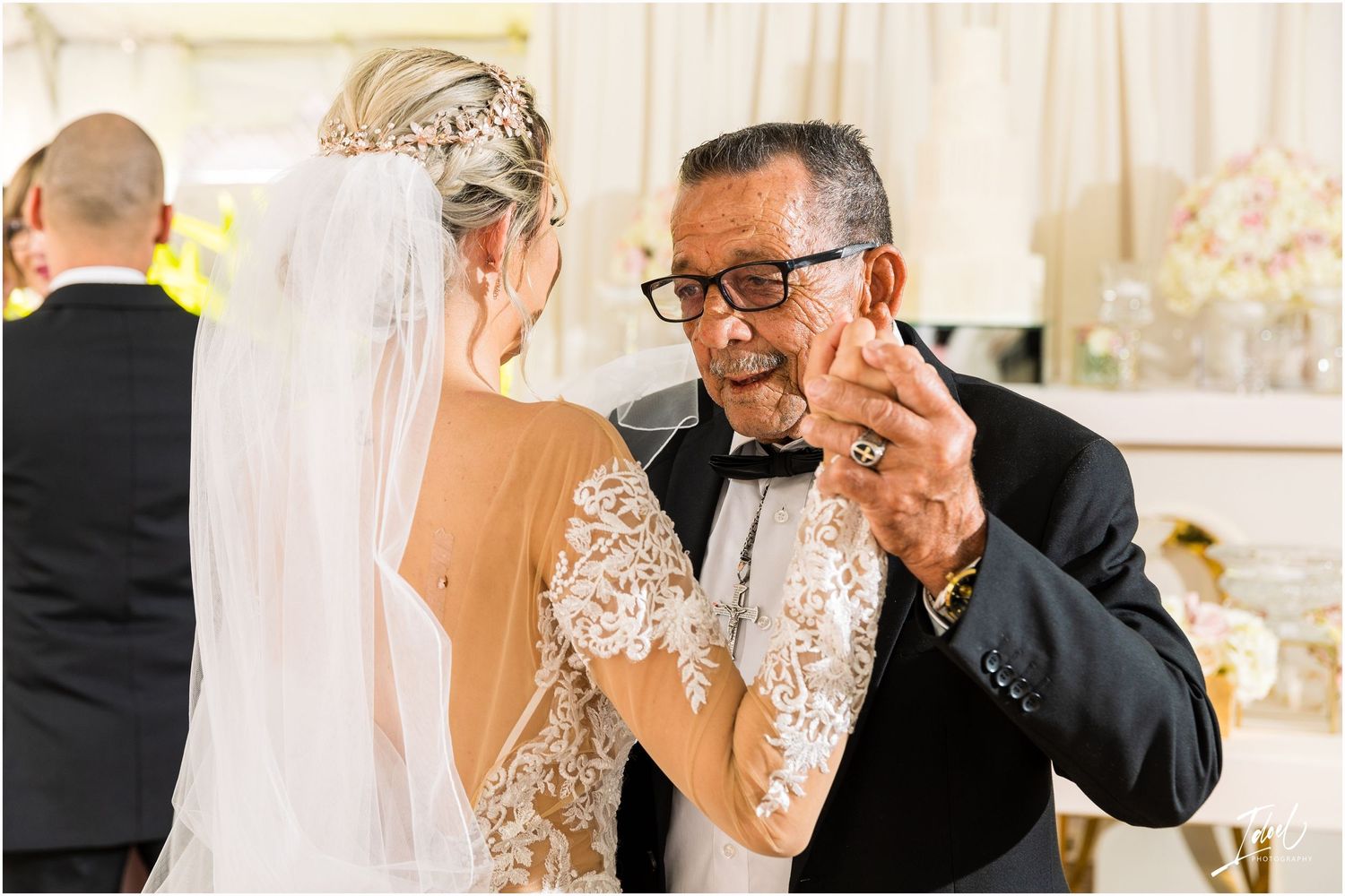 Emotional dance captured during wedding reception with expressions of joy.