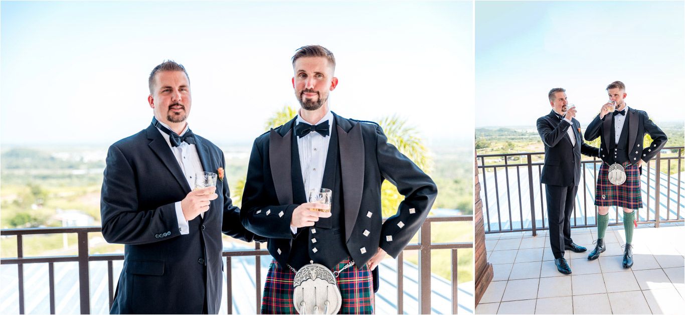 Wedding party members in formal attire and kilts socialize on an outdoor balcony.
