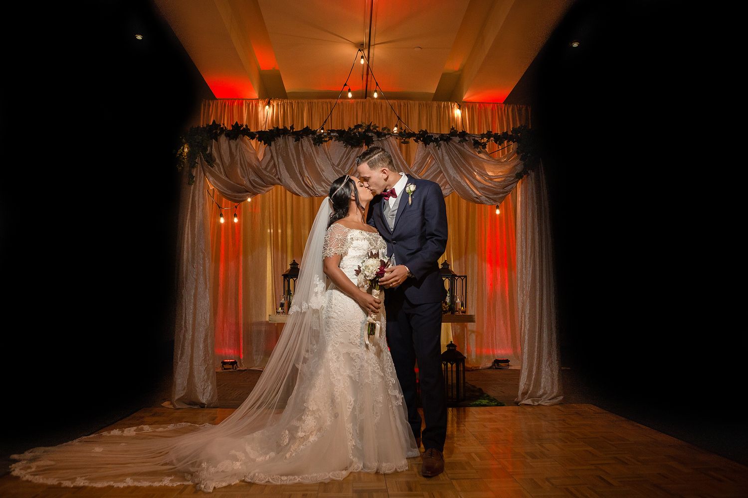 A series of wedding ceremony photos showing couples in elegant decor with dramatic red lighting and flowing white drapery.
