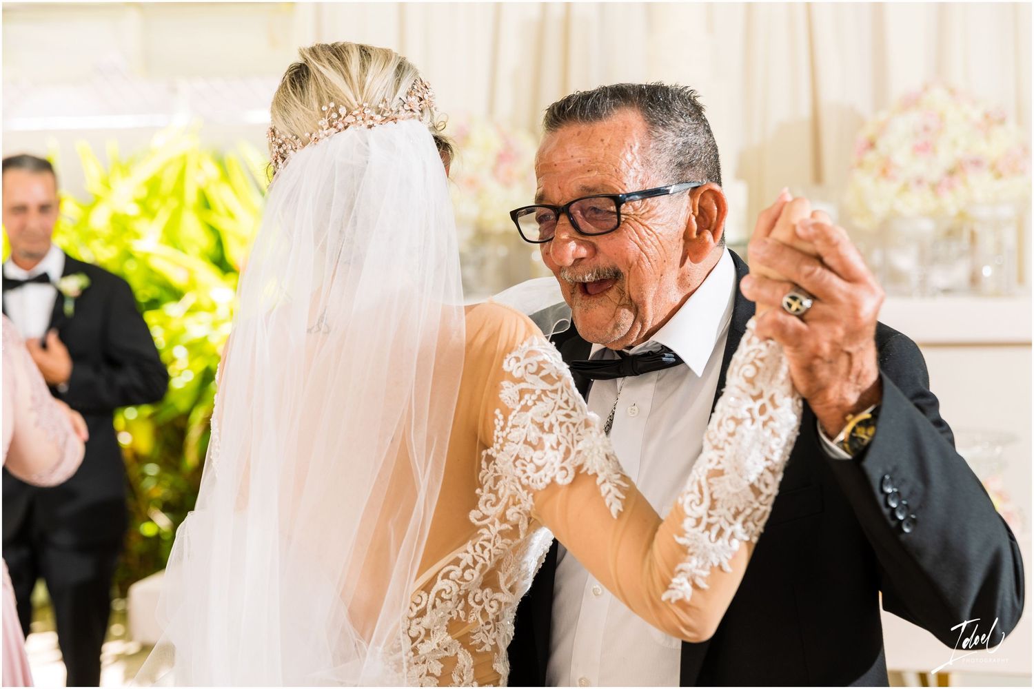 Candid reception moment shows genuine laughter and joy during wedding celebration.