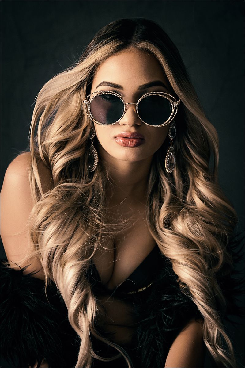 A series of dramatic fashion portraits featuring blonde wavy hair, red lipstick and sunglasses against a dark background.