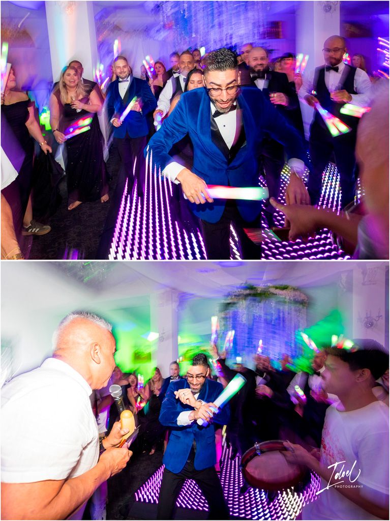 Wedding reception party guests dancing on an illuminated LED dance floor with colorful blue and purple lighting effects.