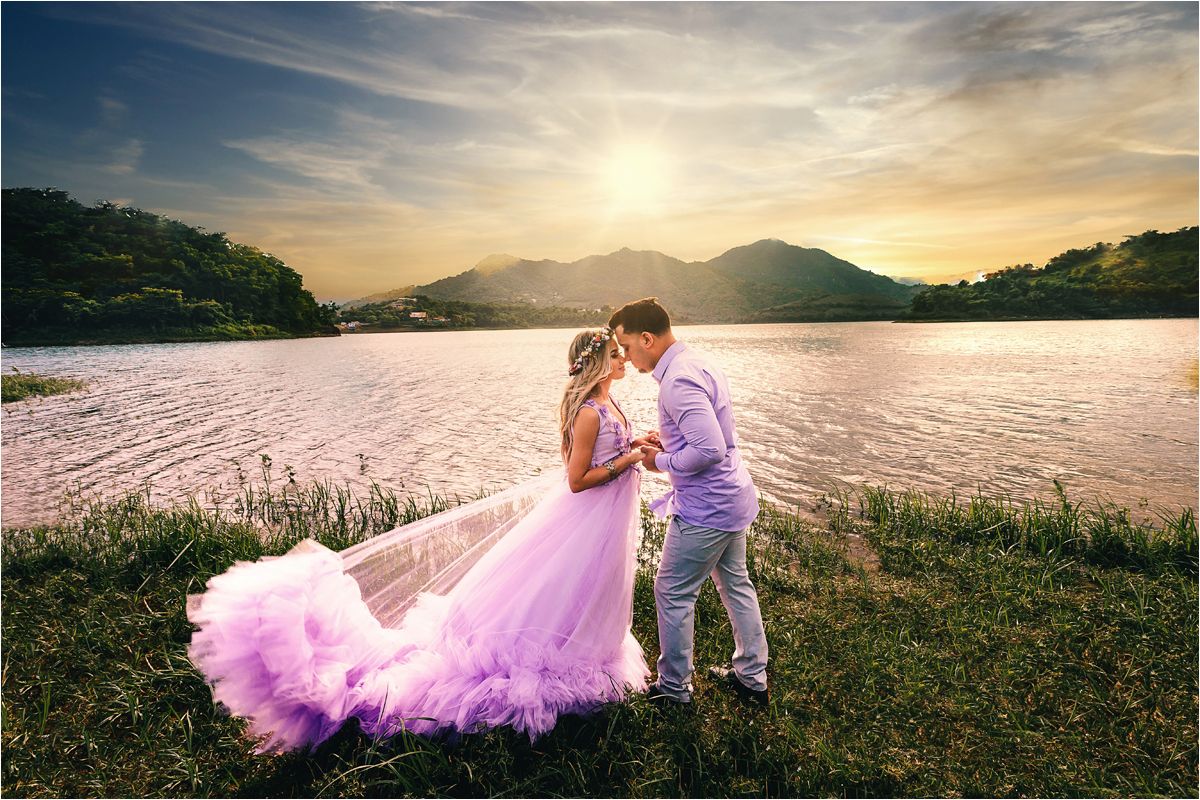 A scenic sunset view over rolling hills with tall grass swaying in the golden evening light.