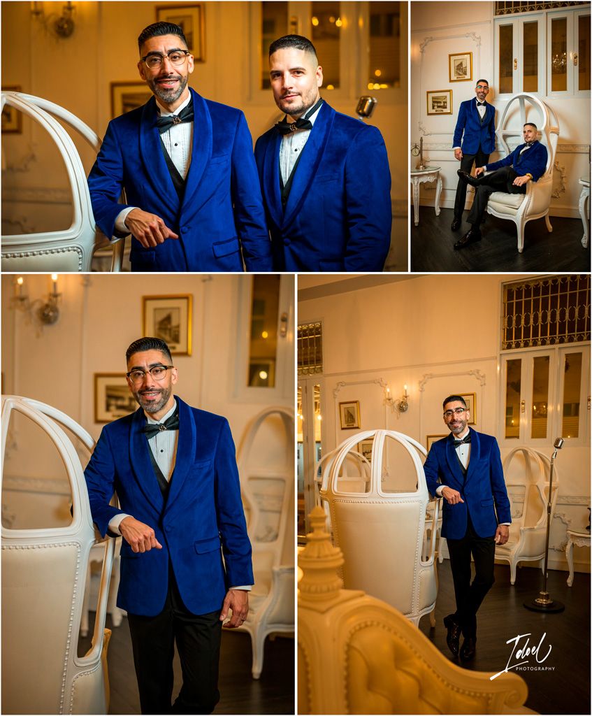 Two people in matching royal blue tuxedos and bow ties pose elegantly in a vintage-style interior setting.