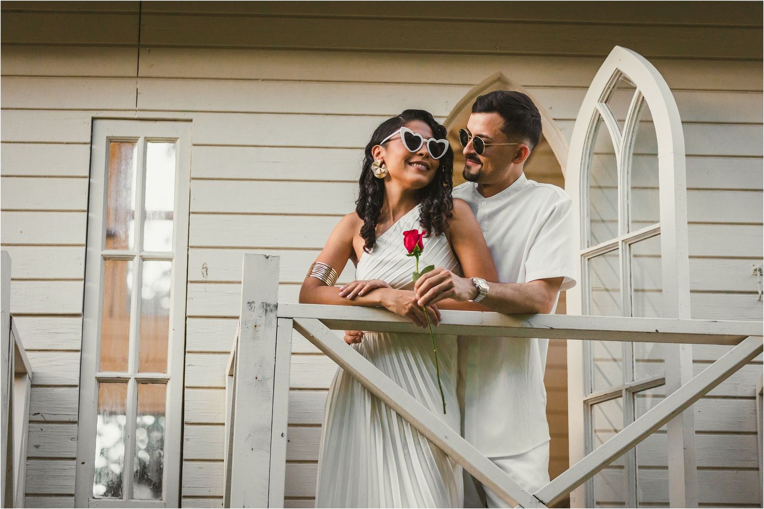 Romantic scene on a white porch with elegant wedding attire.