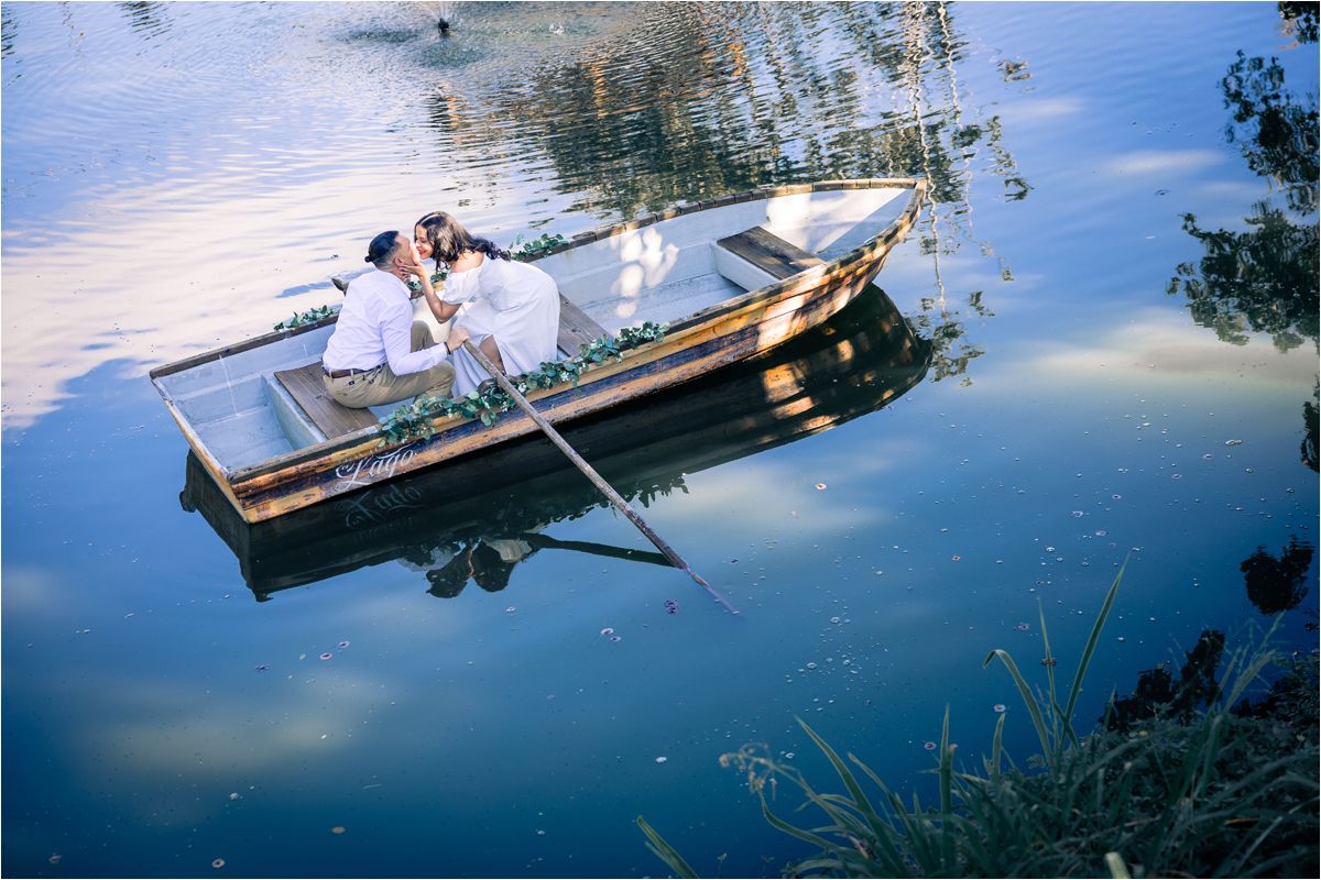 Traditional wooden boats float peacefully on calm reflective waters surrounded by lush greenery.