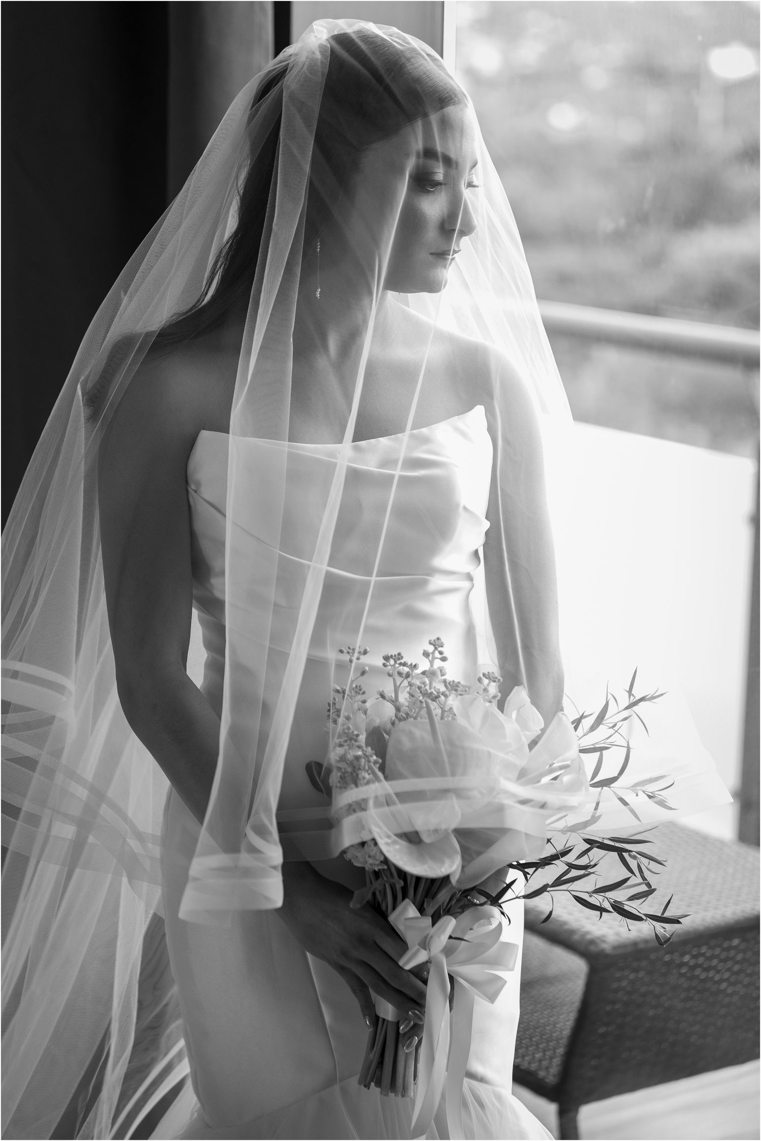 Artistic black and white bridal portraits showing delicate details of veil and bouquet.